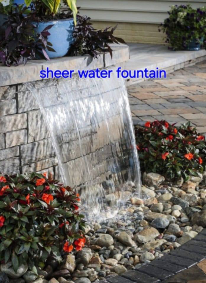 Sheer water fountain over stone wall